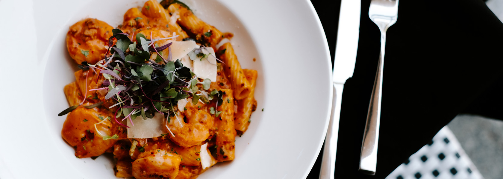 Circular dish of shrimp pasta.