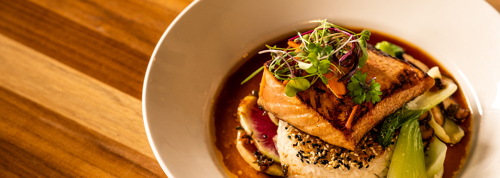 Seared Salmon on jasmine rice with baby bok choy, shiitake mushrooms, pickled ginger and citrus ponzu sauce