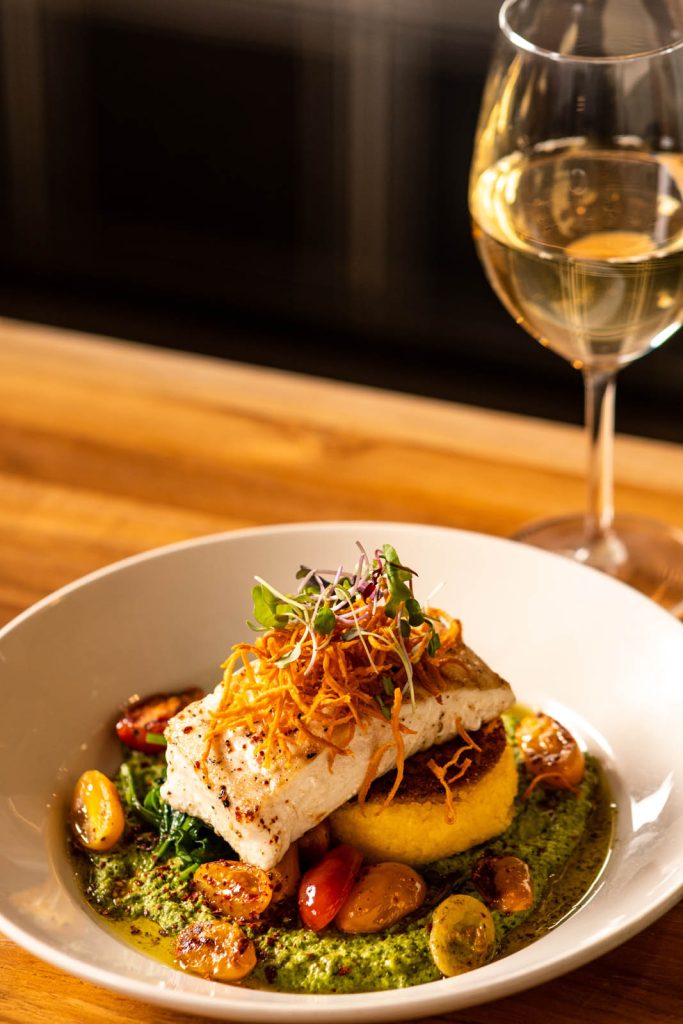 Seared Halibut with glass of wine at Tucci's restaurant in Dublin, Ohio.