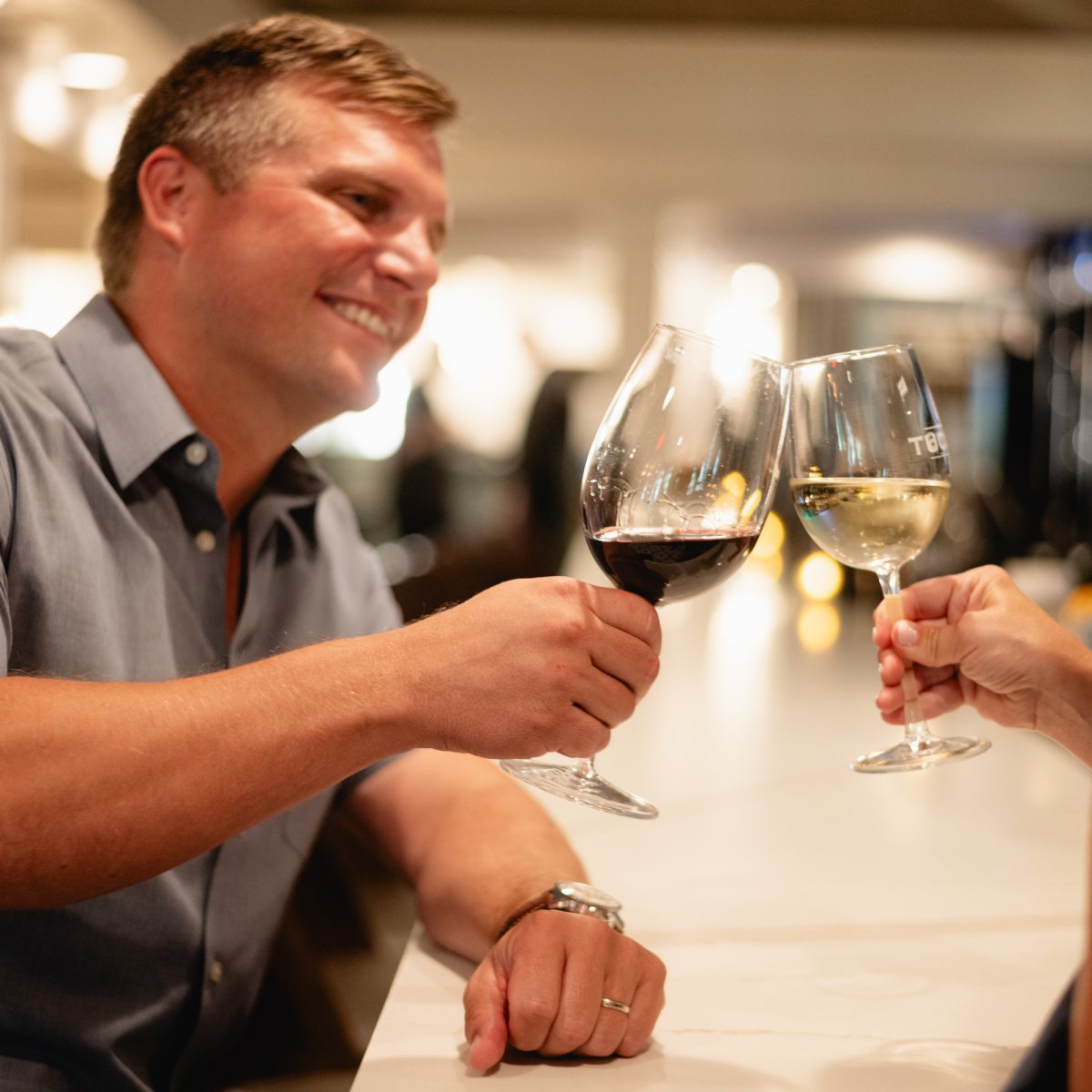 A couple toasting with wine at Tucci's