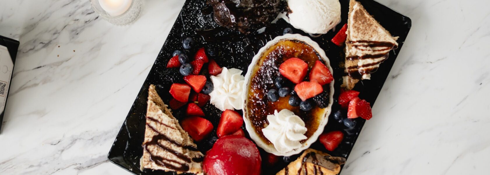 Tucci's dessert board with creme brulee, tiramisu and berries
