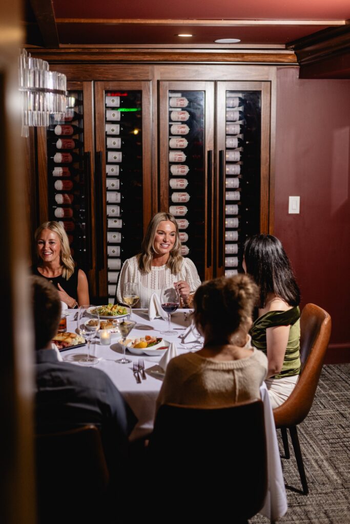 Guests at a private dinner in the Emerald Wine Room at Tucci's