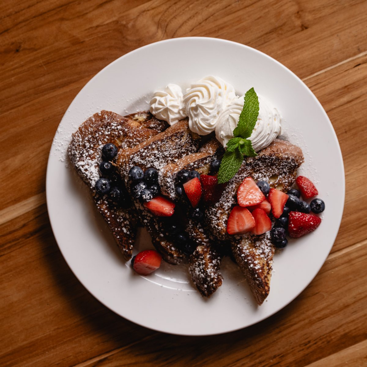 Brioche French toast with berries and whipped cream at Tucci's weekend brunch