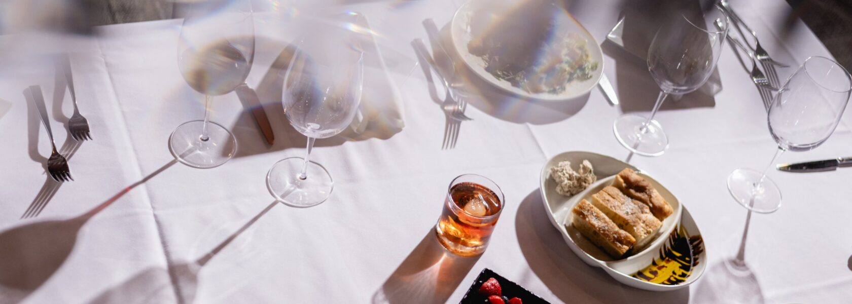 Cocktails and bar bites on a table at Tucci's