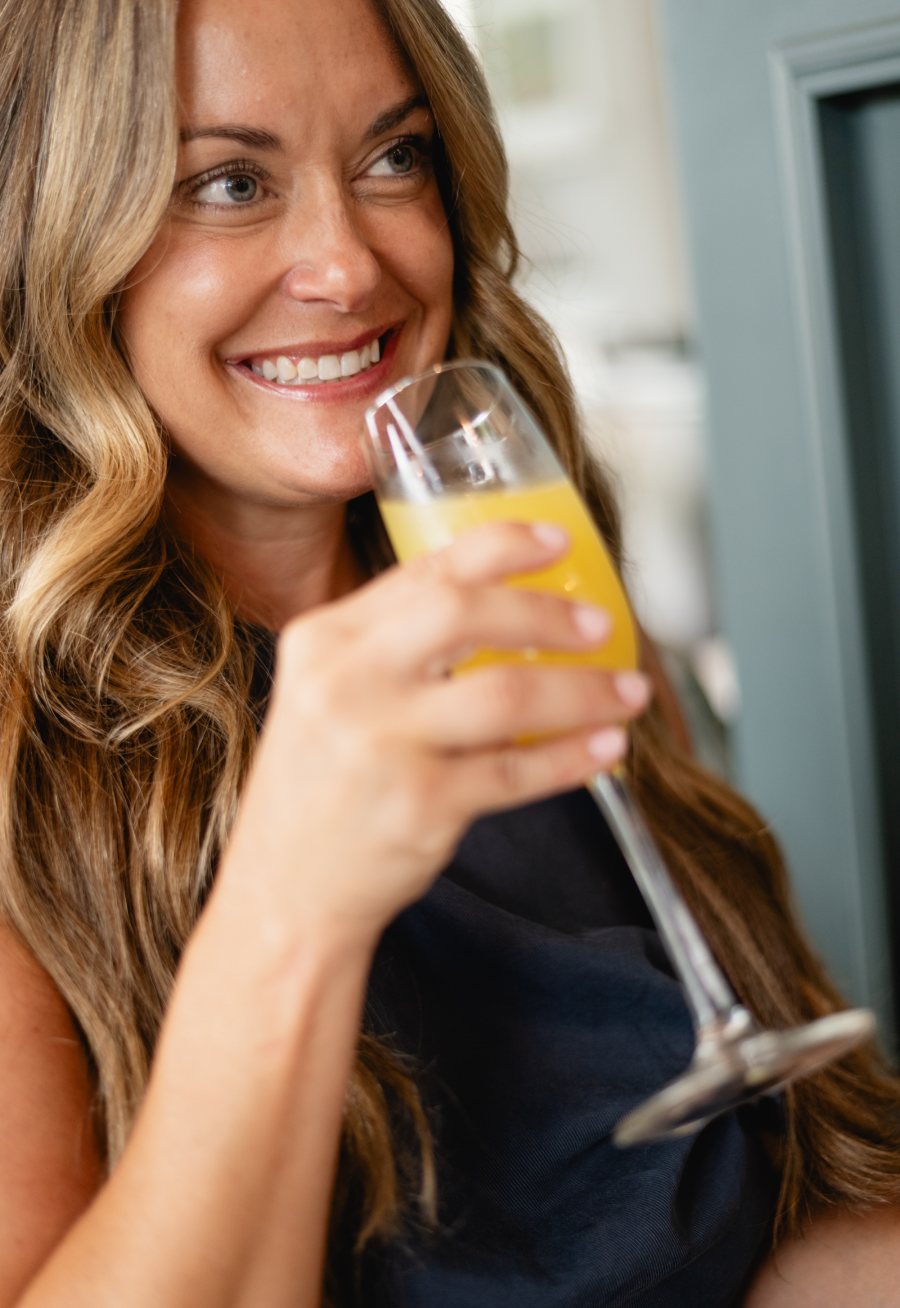 A guest with a mimosa at Tucci's weekend brunch