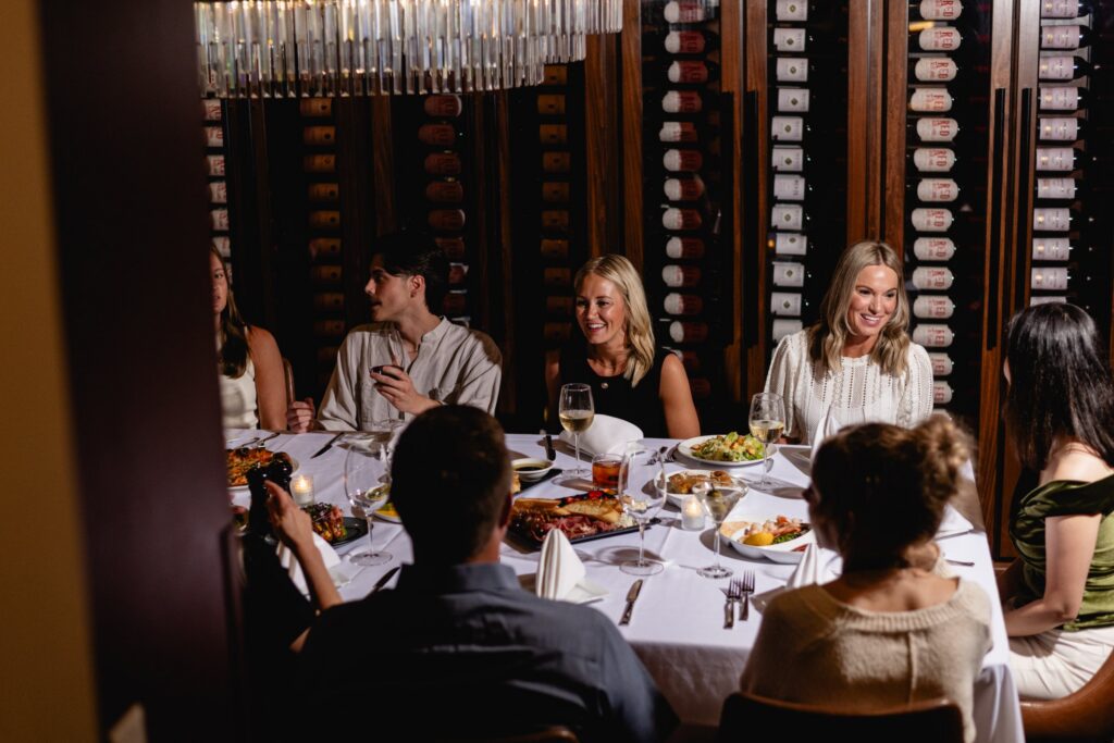 A group dining in the Emerald Wine Room at Tucci's