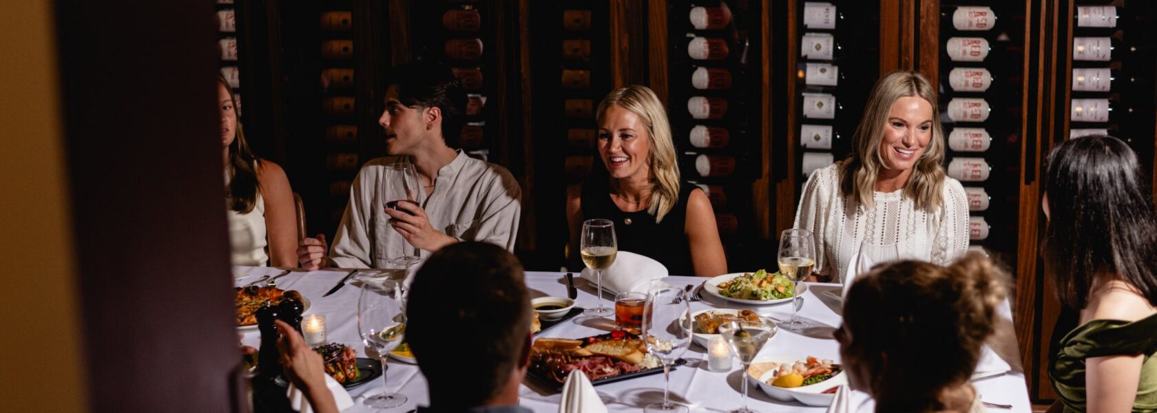 A group dining in the Emerald Wine Room at Tucci's