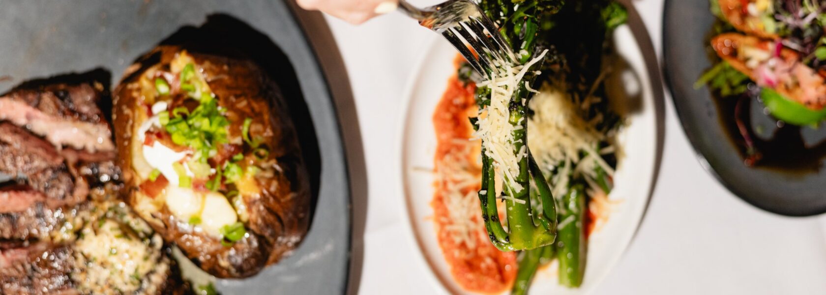 Steak dinner with asparagus and sides at Tucci's